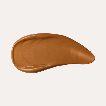 Bronzing serum swipe, smooth medium-bronze shimmer gel on a flat curve