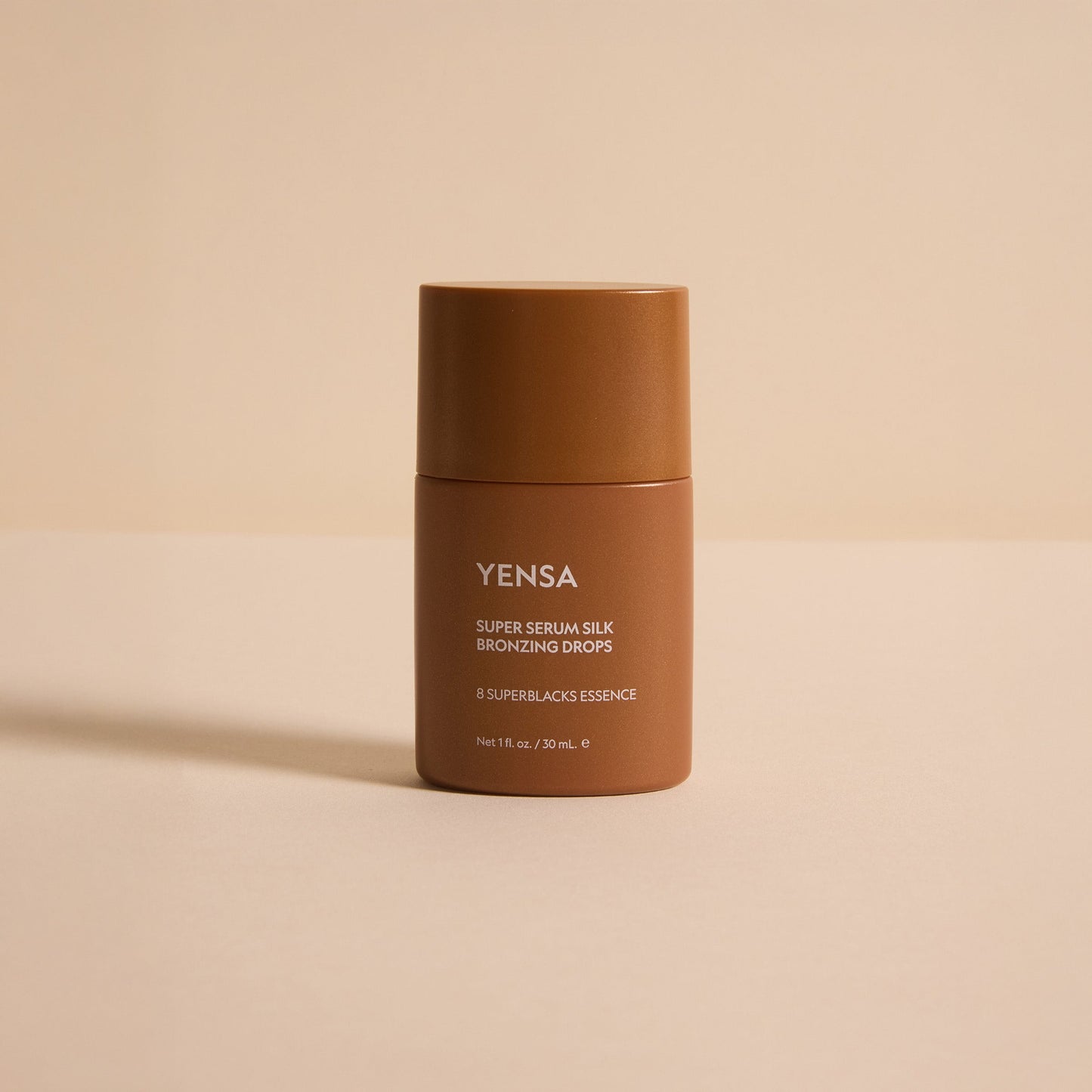 Bronzing serum bottle, dark bronze container with YENSA label and flip-top cap