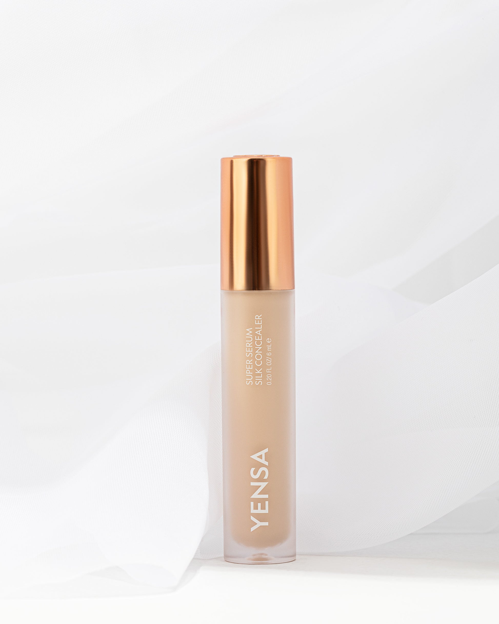YENSA concealer serum bottle with gold cap, beige liquid in frosted tube