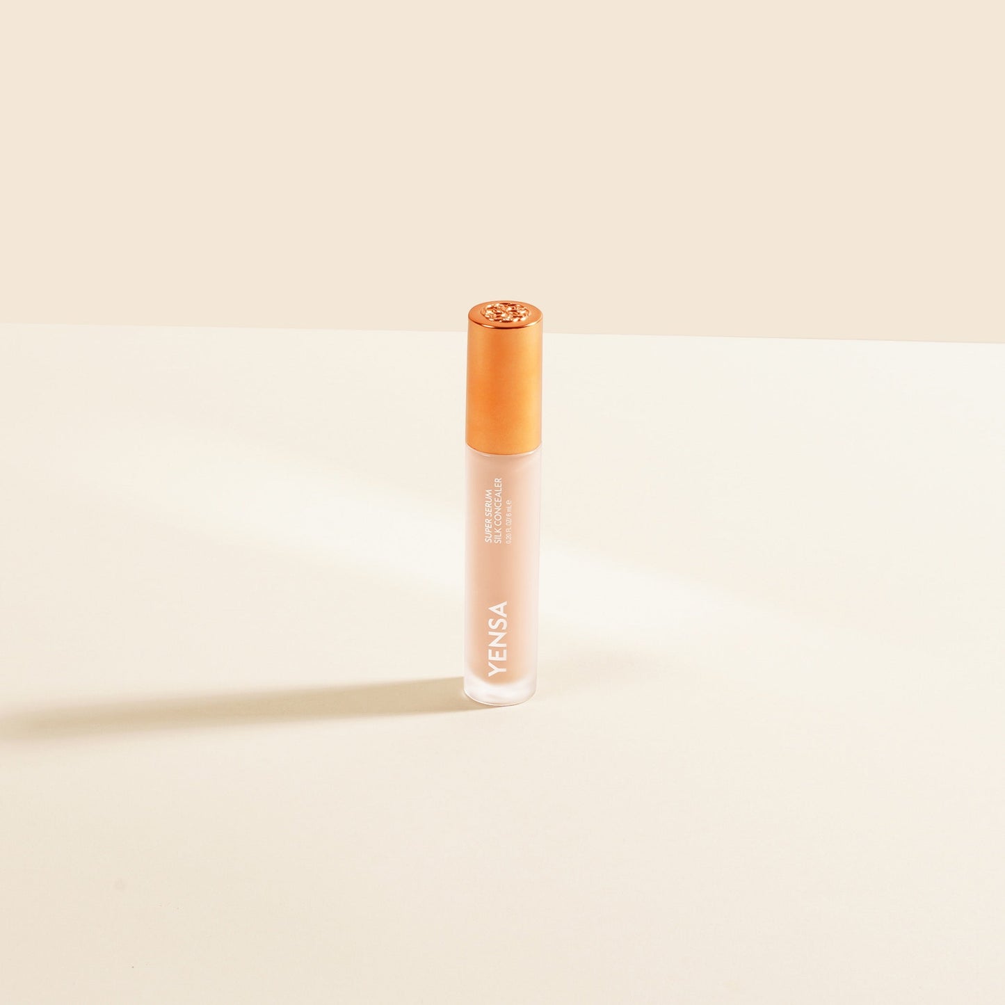 YENSA concealer serum bottle with gold cap, light beige liquid, upright