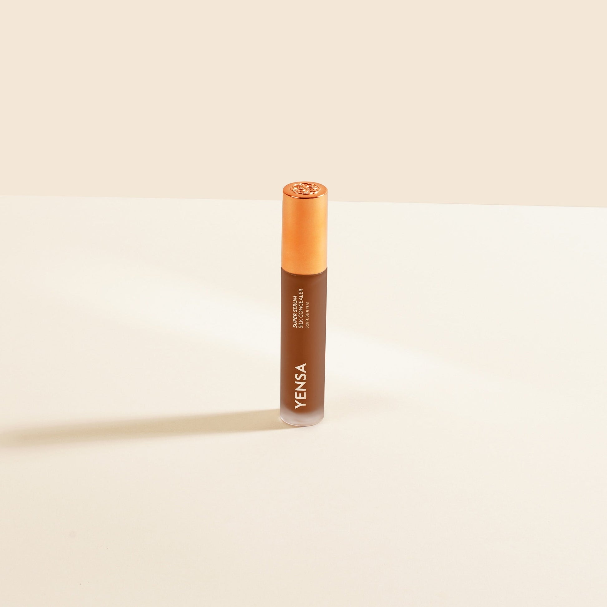 Silk concealer bottle with rose-gold cap, medium-toned concealer