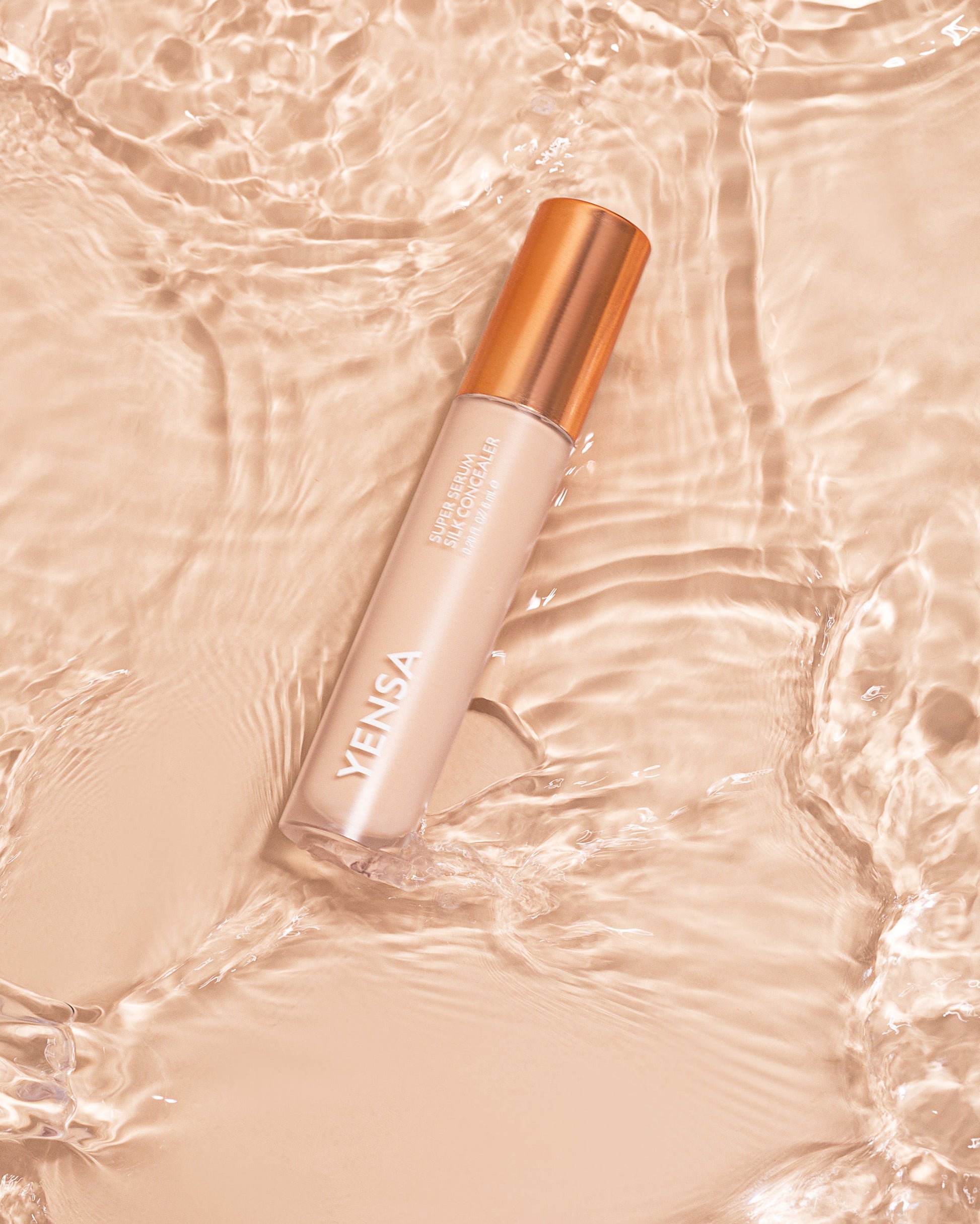 Silk concealer bottle with rose-gold cap, light beige shade