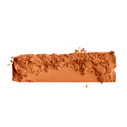Pressed foundation powder sample in medium-deep tan with crumbled texture