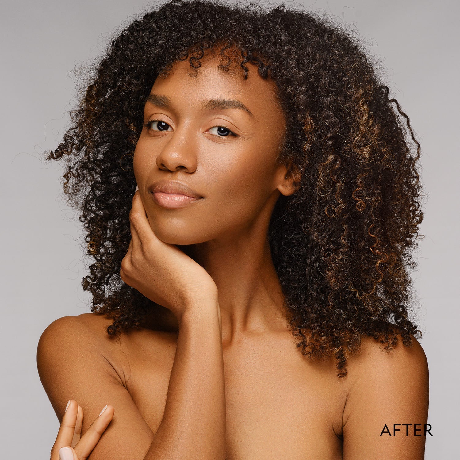 Matte powder foundation finish on model face with hand near cheek