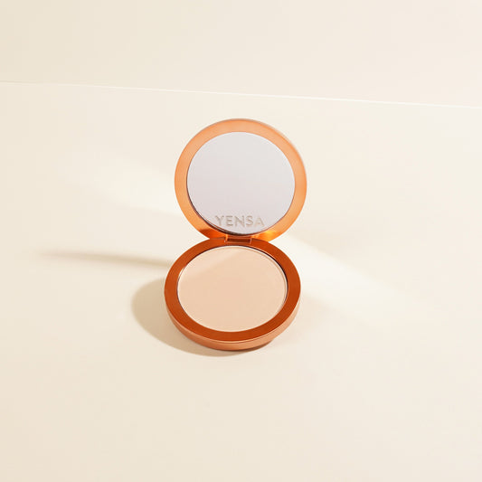 Silk matte powder foundation compact with open lid, peach-beige powder disc