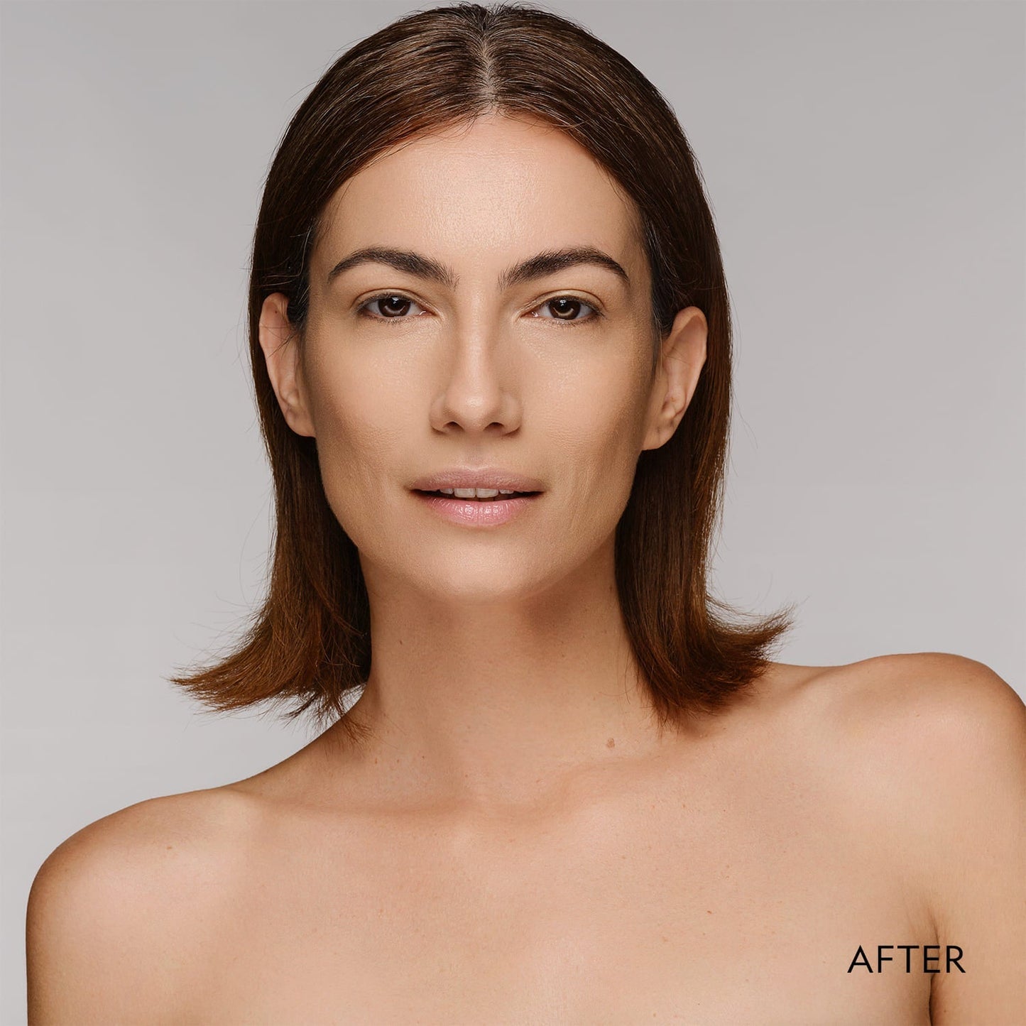 Woman showing smooth matte finish after applying powder foundation