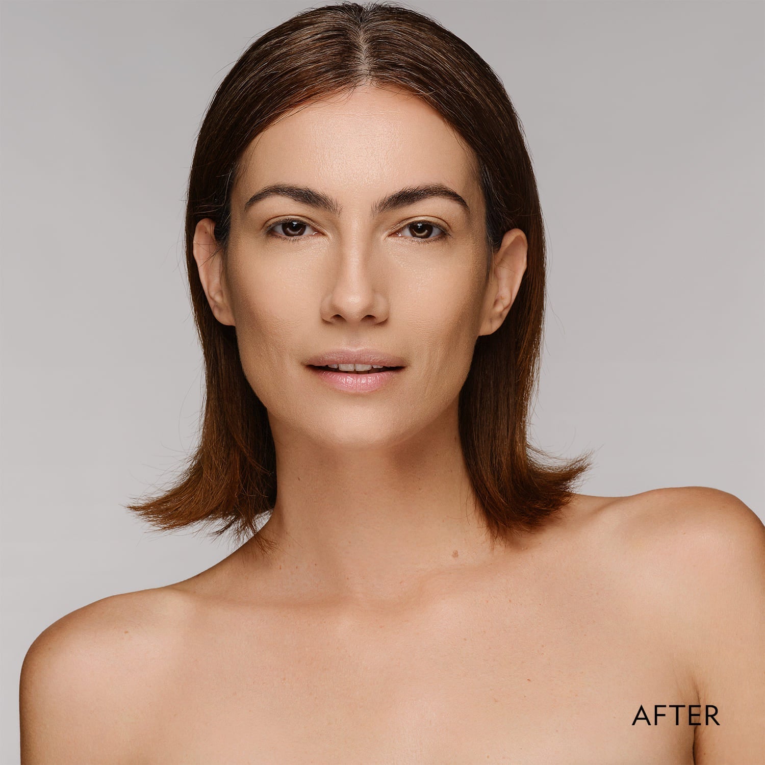 Woman showing smooth matte finish after applying powder foundation