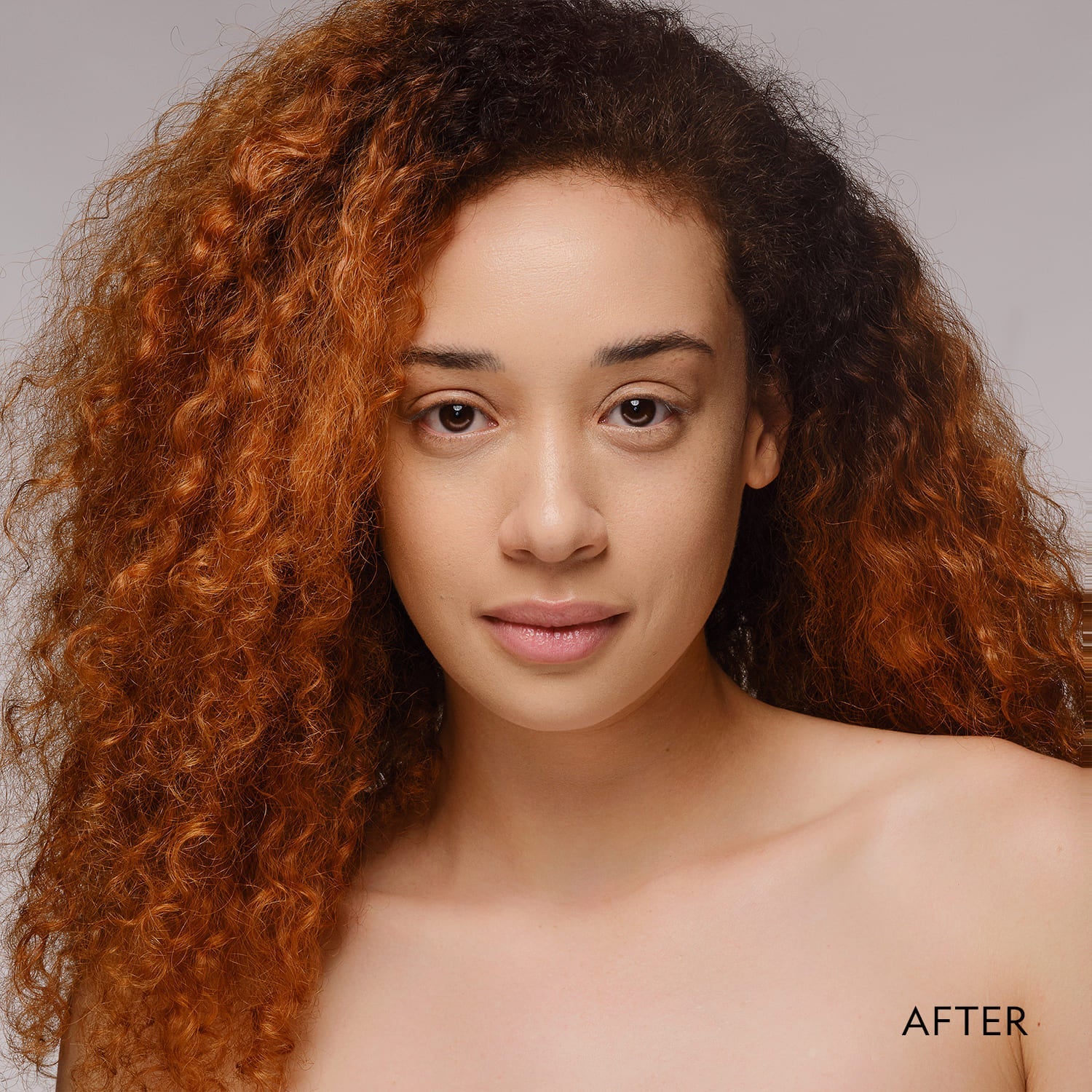 Woman with smooth complexion wearing powder foundation, straight-on view