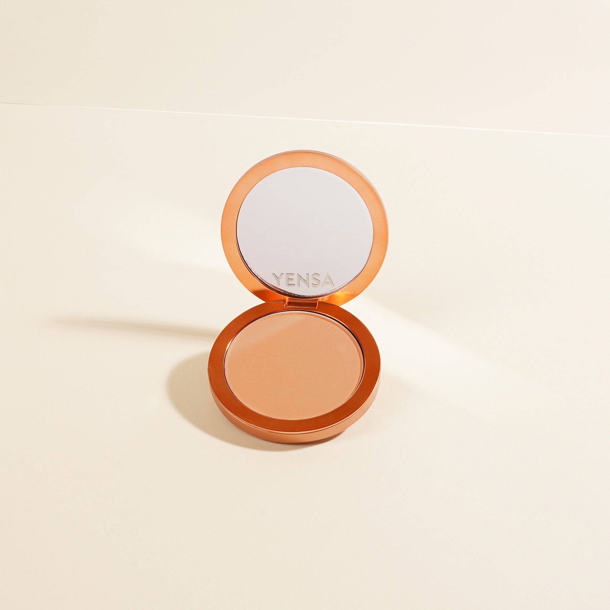 Matte powder foundation compact with open lid and light beige powder inside