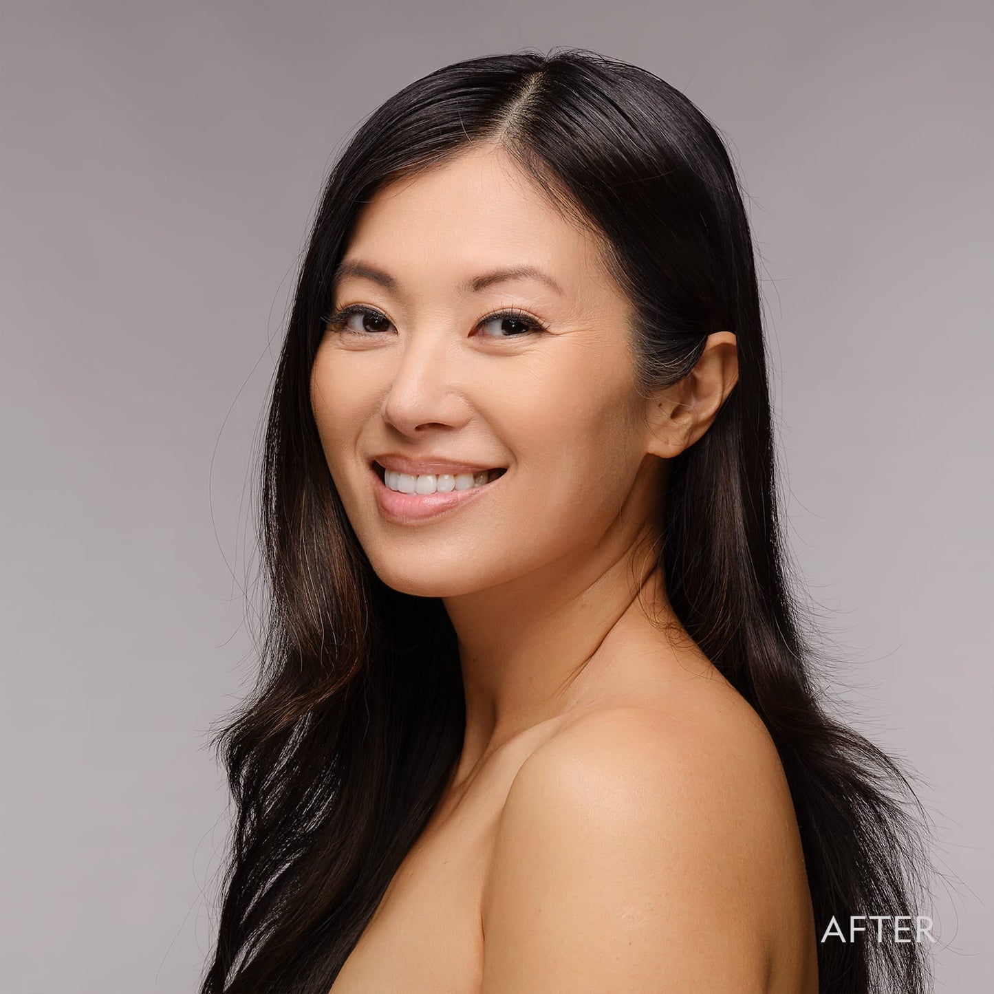 Woman with smooth complexion wearing powder foundation, smiling
