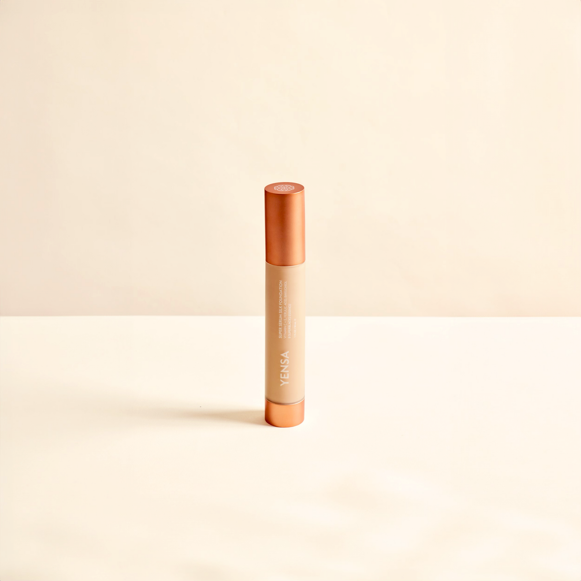 Hydrating foundation tube with orange cap and beige dispenser, front view