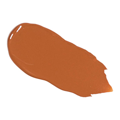Deep tan liquid foundation swatch with glossy, blended look