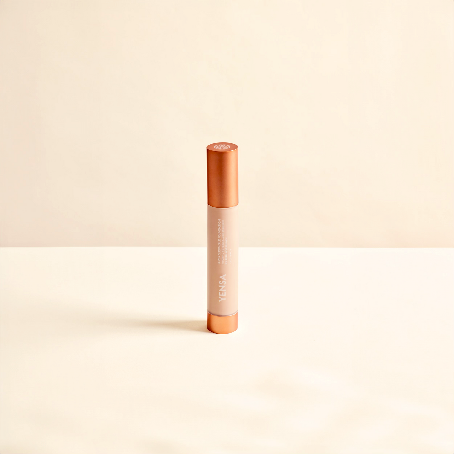 Hydrating foundation tube with orange cap and beige body, upright view