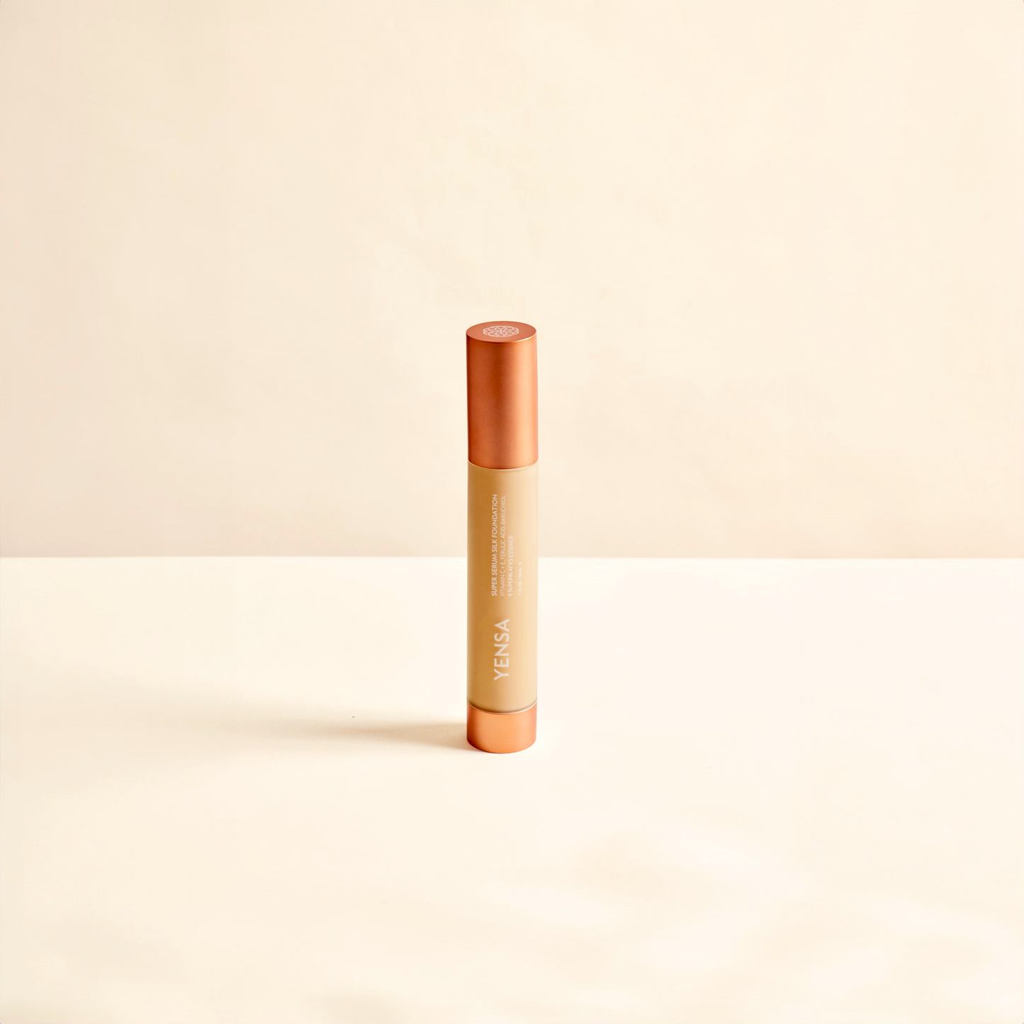 Hydrating foundation tube standing, orange cap and beige applicator