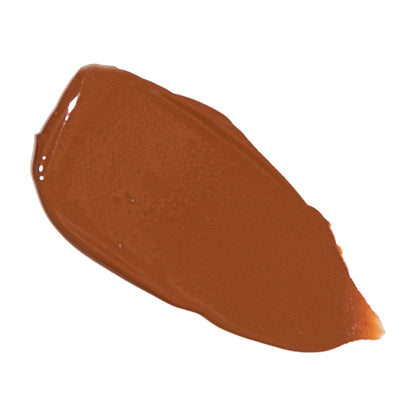 Foundation swatch in warm medium brown on smooth skin-tone patch