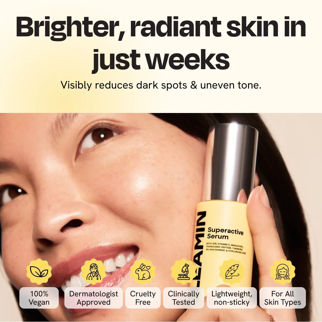 Face serum bottle held near a woman’s cheek for brightening treatment