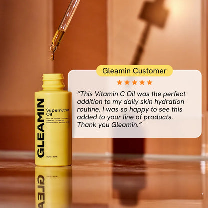 Facial oil bottle with dropper dispensing amber drops