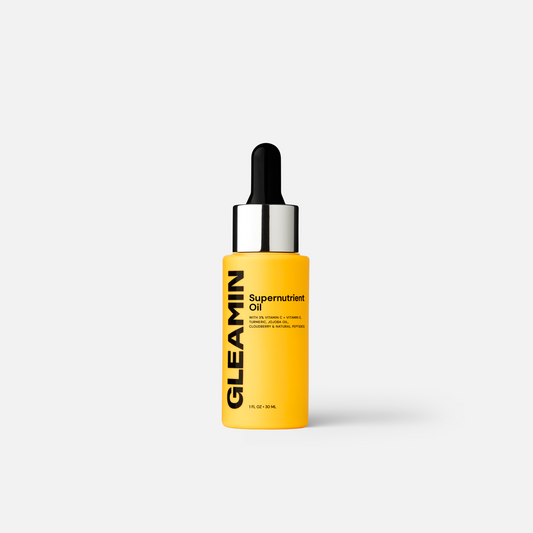 Facial oil bottle with black dropper and yellow amber serum