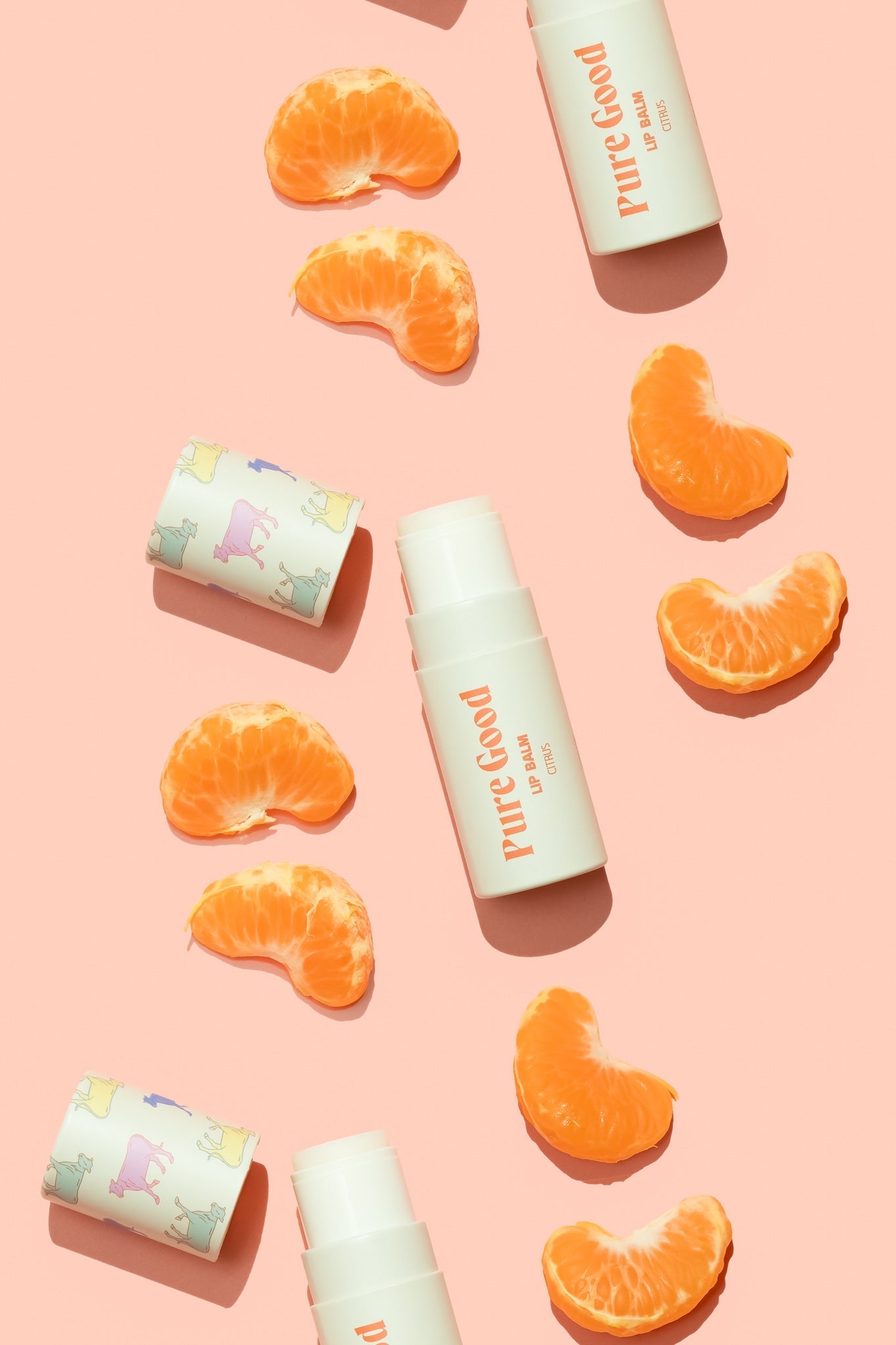 Tallow lip balm with orange flavor tube and orange wedges arranged around it