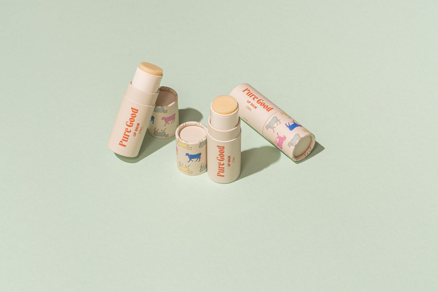 Tallow lip balm tubes with colorful Pure Good animal prints and cream caps
