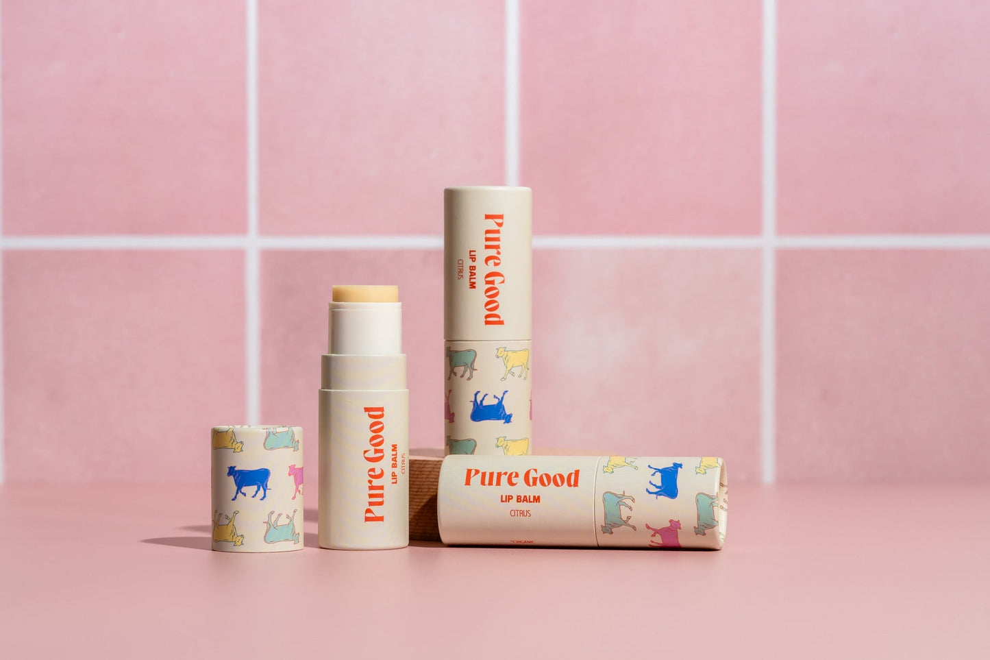 Tallow lip balm tubes with Pure Good animal graphics in white, red, and multicolor designs