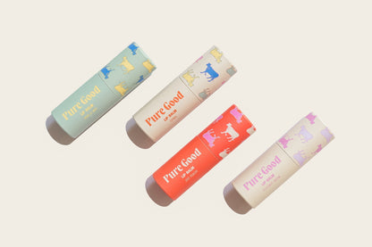 Tallow lip balm tubes in mint, cream, coral orange, and pale purple with Pure Good labels
