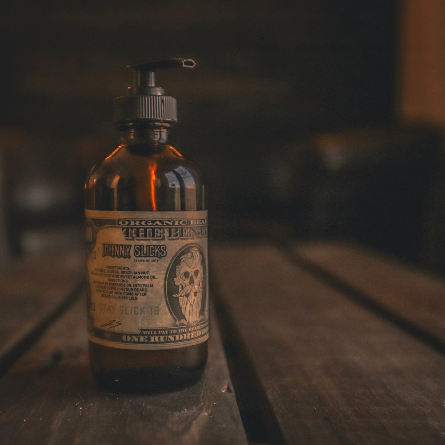 Amber glass beard oil bottle with black pump, label for Benjamin by Johnny Slicks