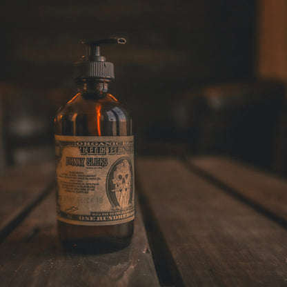Amber glass beard oil bottle with black pump, label for Benjamin by Johnny Slicks