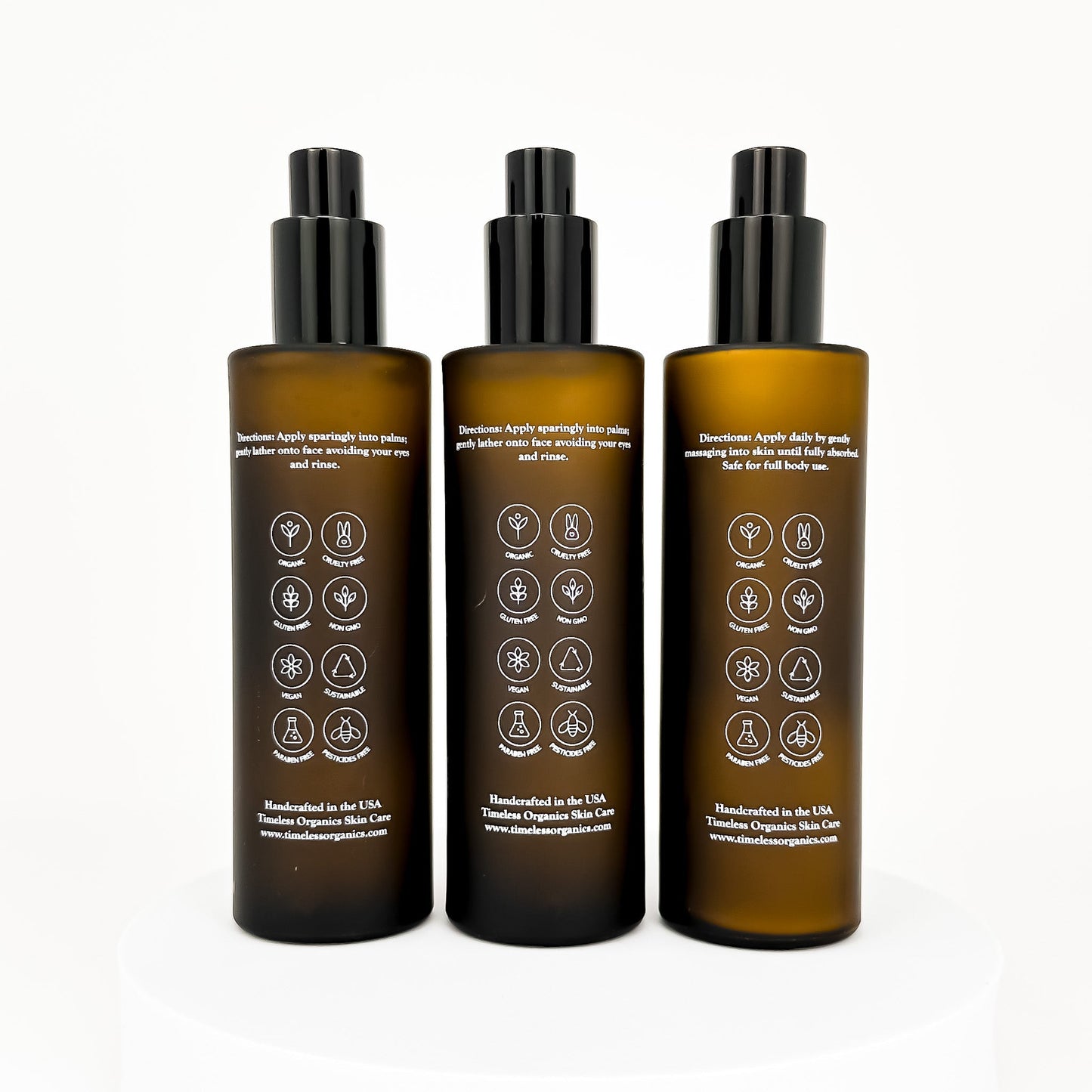 Back view of three amber acne skincare bottles with black caps and label icons
