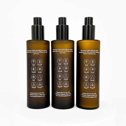 Back view of three amber acne skincare bottles with black caps and label icons