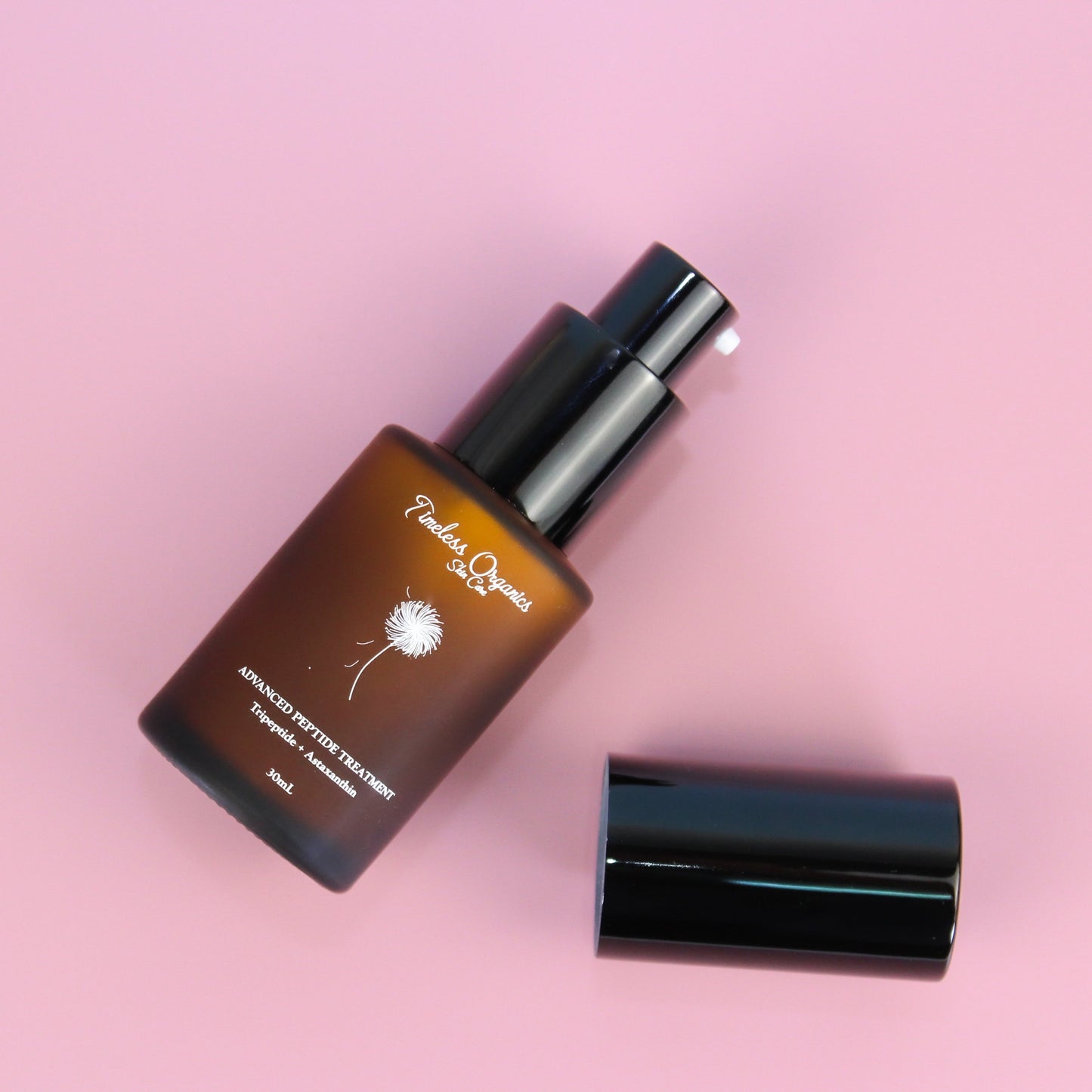 Peptide treatment moisturizer bottle with black pump and cap, amber container