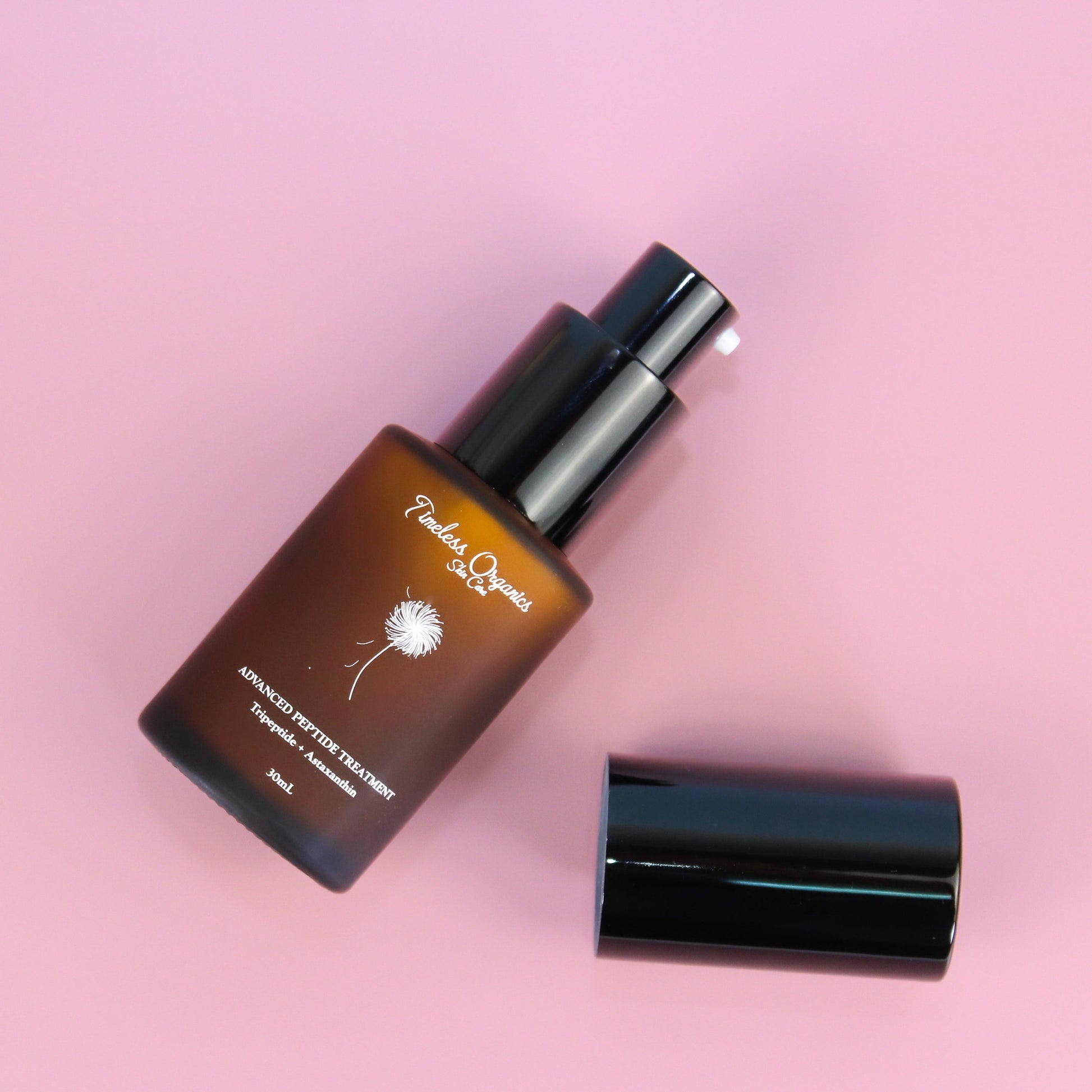 Peptide treatment moisturizer bottle with black pump and cap, amber container