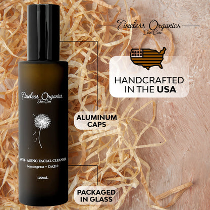 Anti-aging facial cleanser bottle with black pump on shredded paper packaging