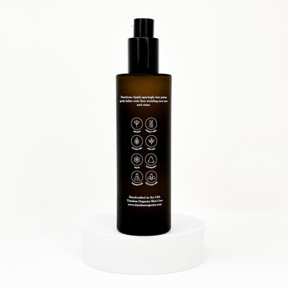 Anti-aging facial cleanser bottle with black pump, back label with icons and directions