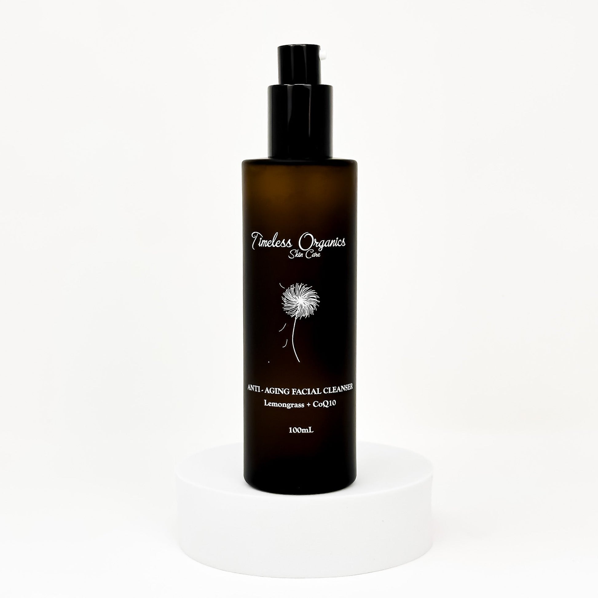 Anti-aging facial cleanser bottle with black pump, amber liquid, 100mL label