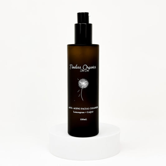 Anti-aging facial cleanser bottle with black pump, amber liquid, 100mL label