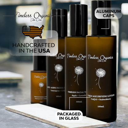 Anti-aging skincare kit bottles with black caps, aluminum cap label, glass packaging