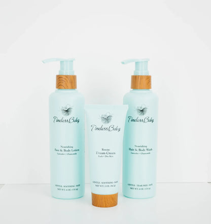 Baby skincare set: two light blue pump bottles and a cream tube with bamboo caps