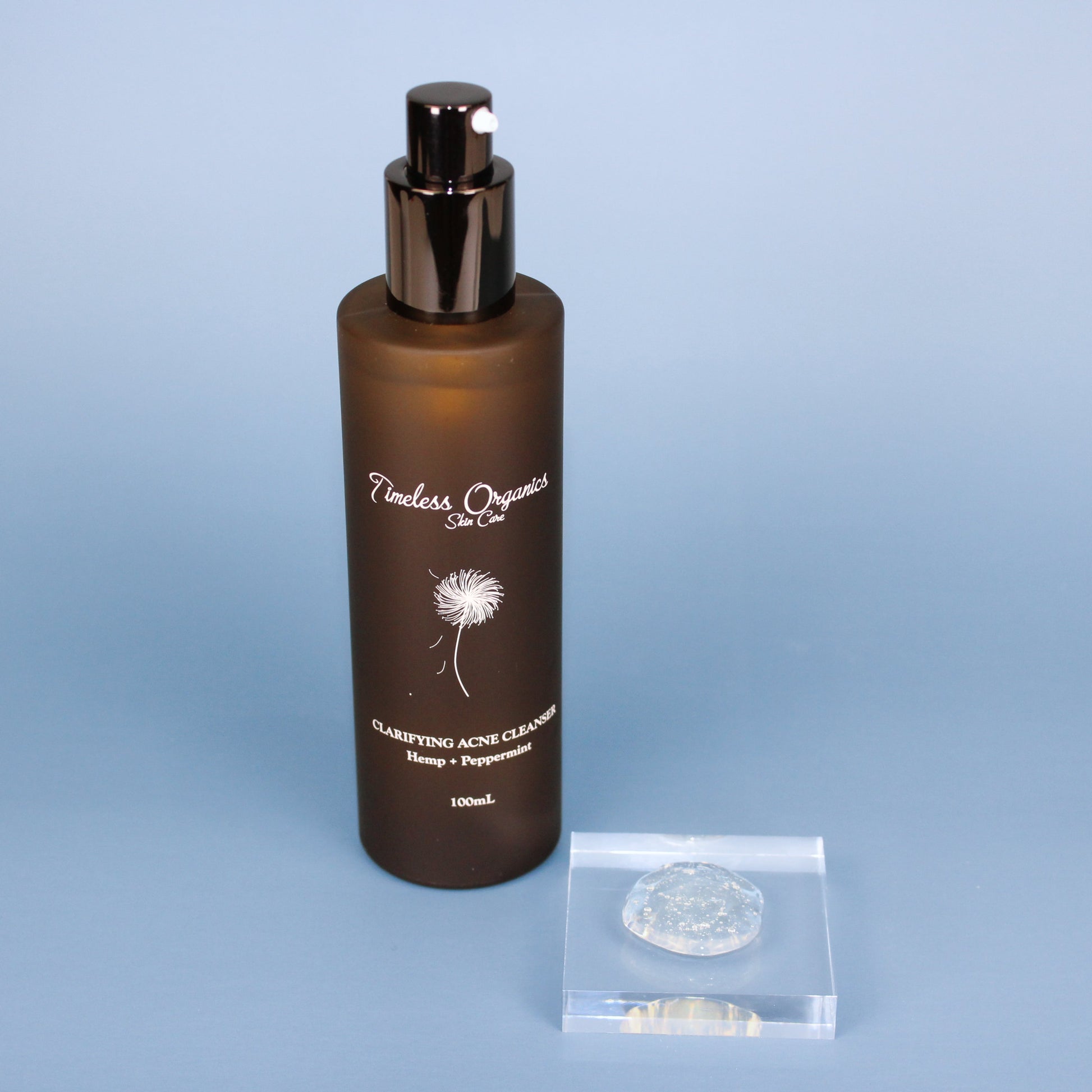 Clarifying acne gel cleanser bottle with black pump and included clear gel scoop pouch