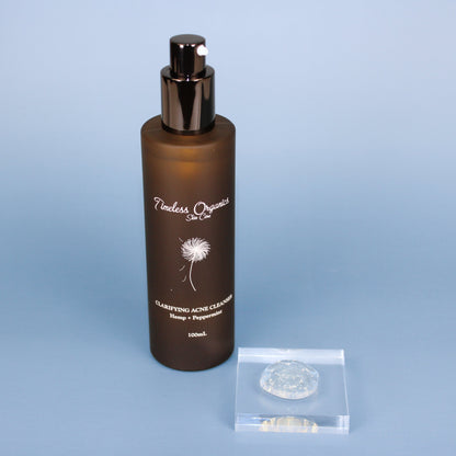 Clarifying acne gel cleanser bottle with black pump and included clear gel scoop pouch