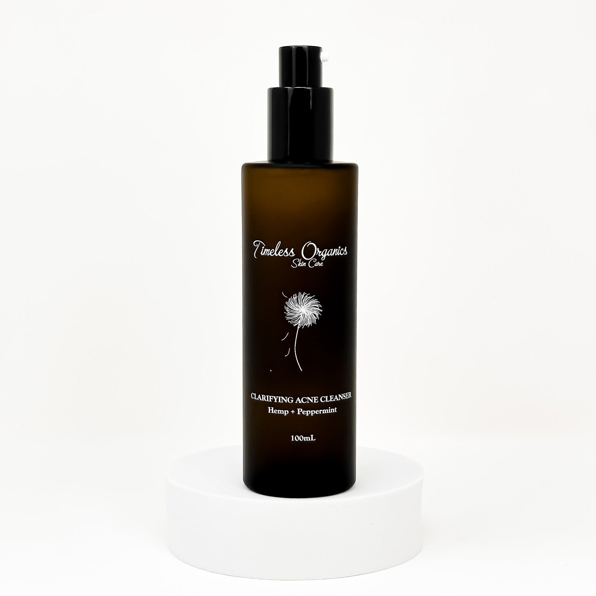 Clarifying acne gel cleanser bottle with black pump, amber label, 100 mL
