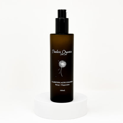 Clarifying acne gel cleanser bottle with black pump, amber label, 100 mL