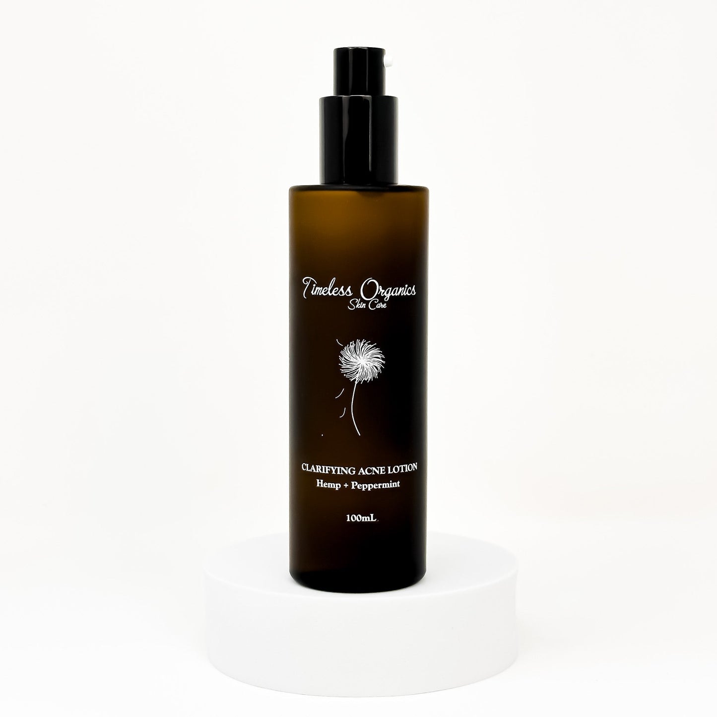 Clarifying acne lotion bottle with black pump, amber label, hemp + peppermint