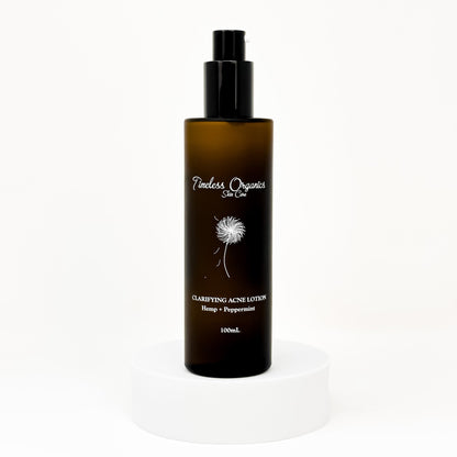 Clarifying acne lotion bottle with black pump, amber label, hemp + peppermint