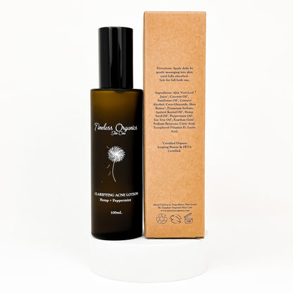 Clarifying acne lotion bottle with black pump and cardboard carton beside it