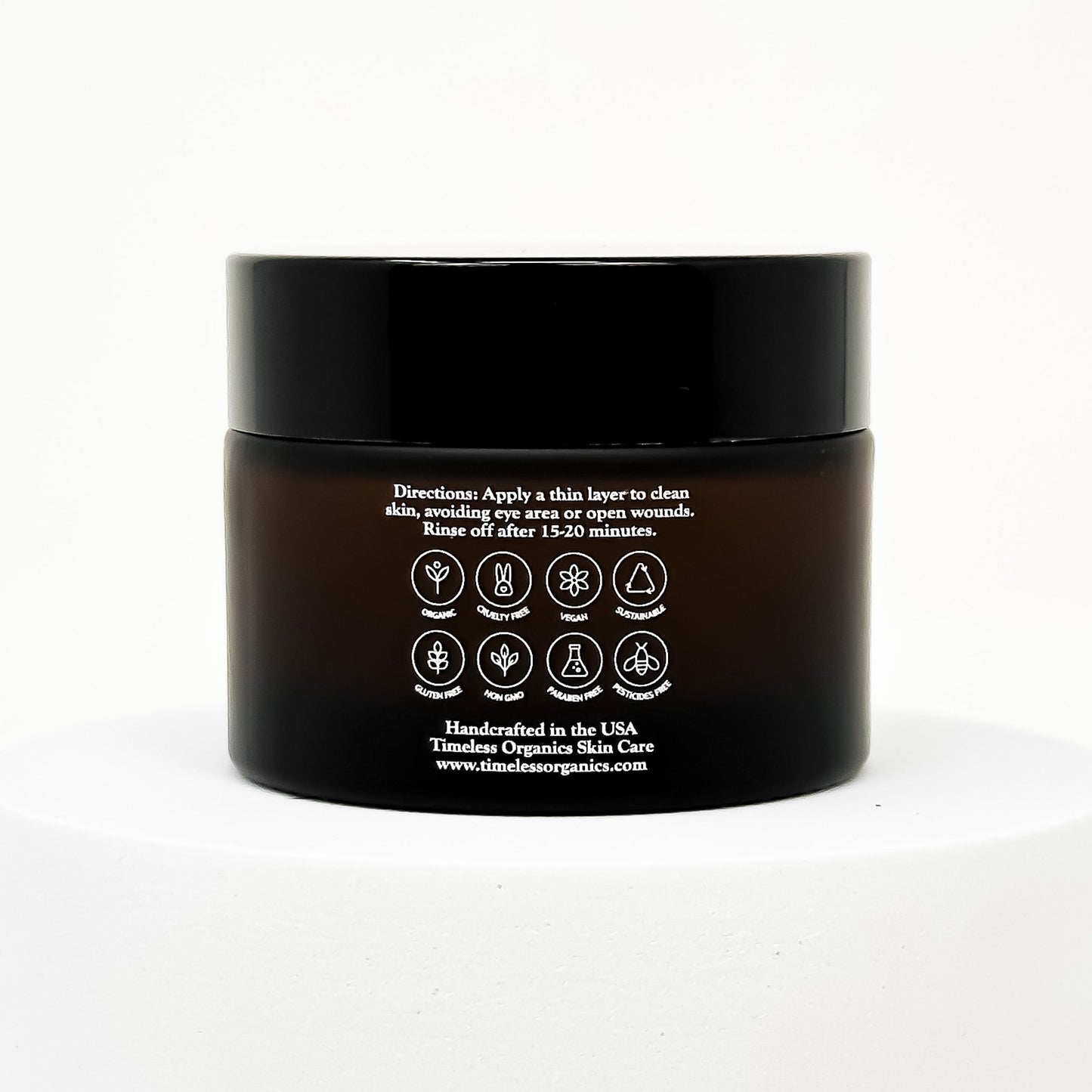 Black clay face mask jar with back label instructions and icon seals