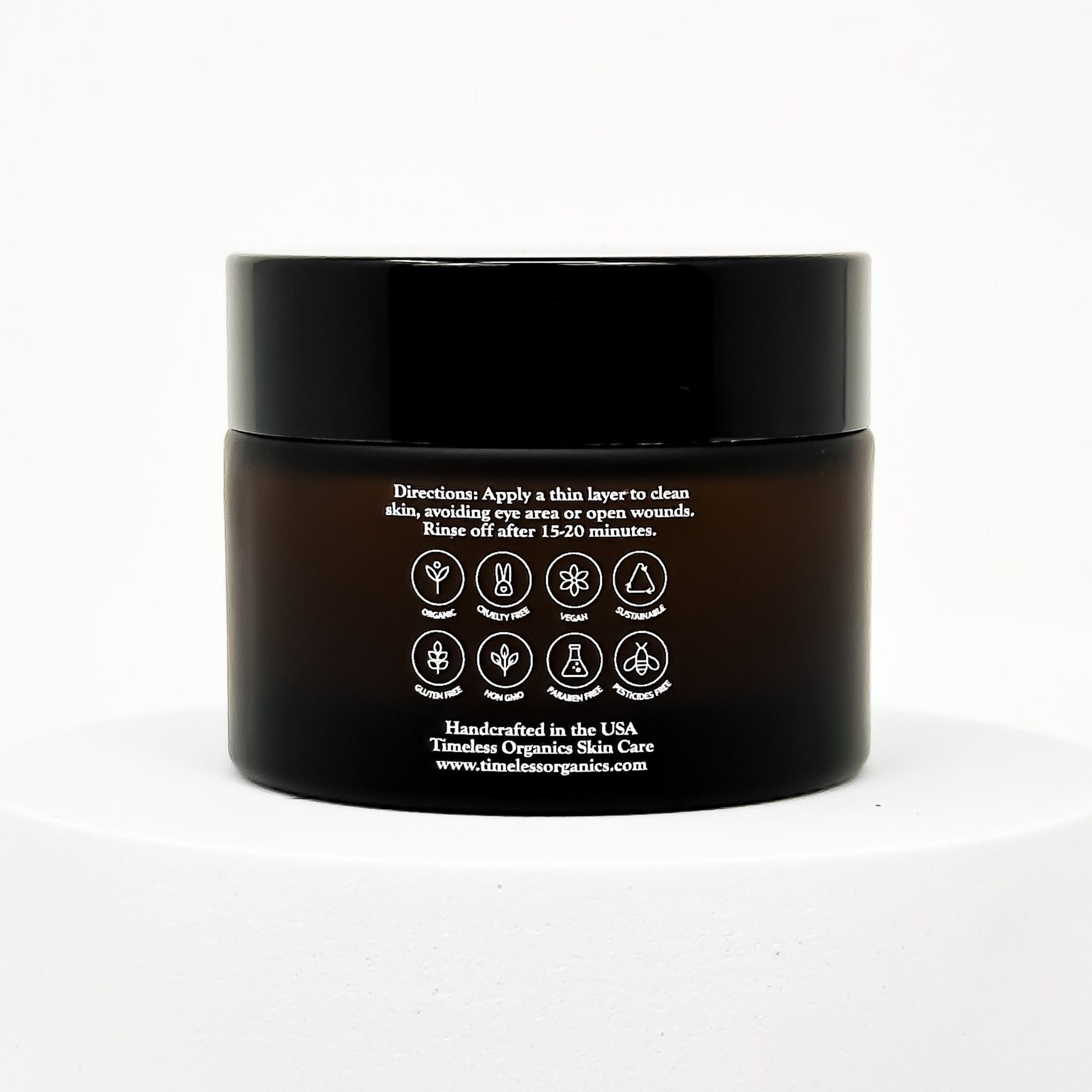 Black clay face mask jar with back label instructions and icon seals