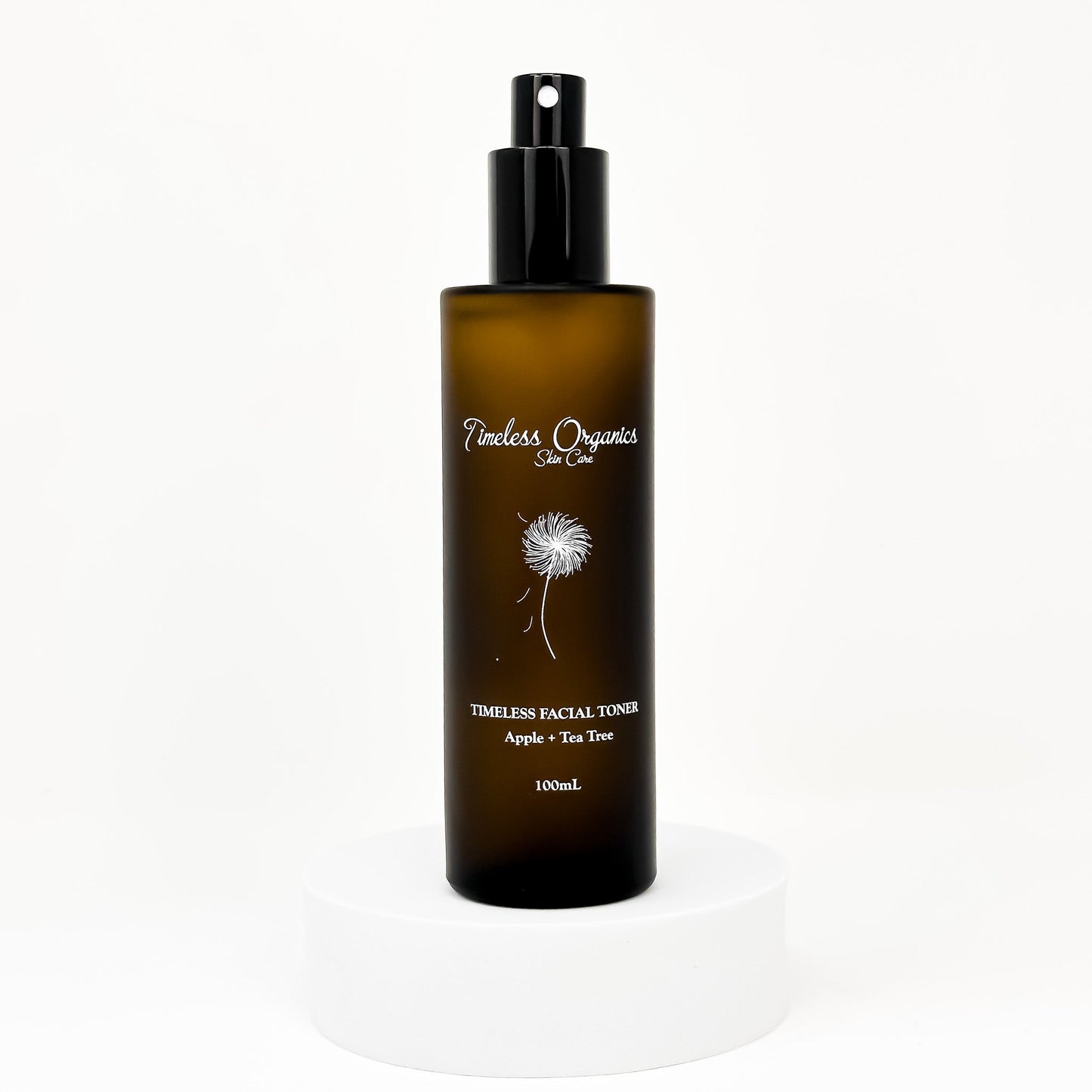 Clarifying facial toner bottle with black pump; amber bottle with dandelion label