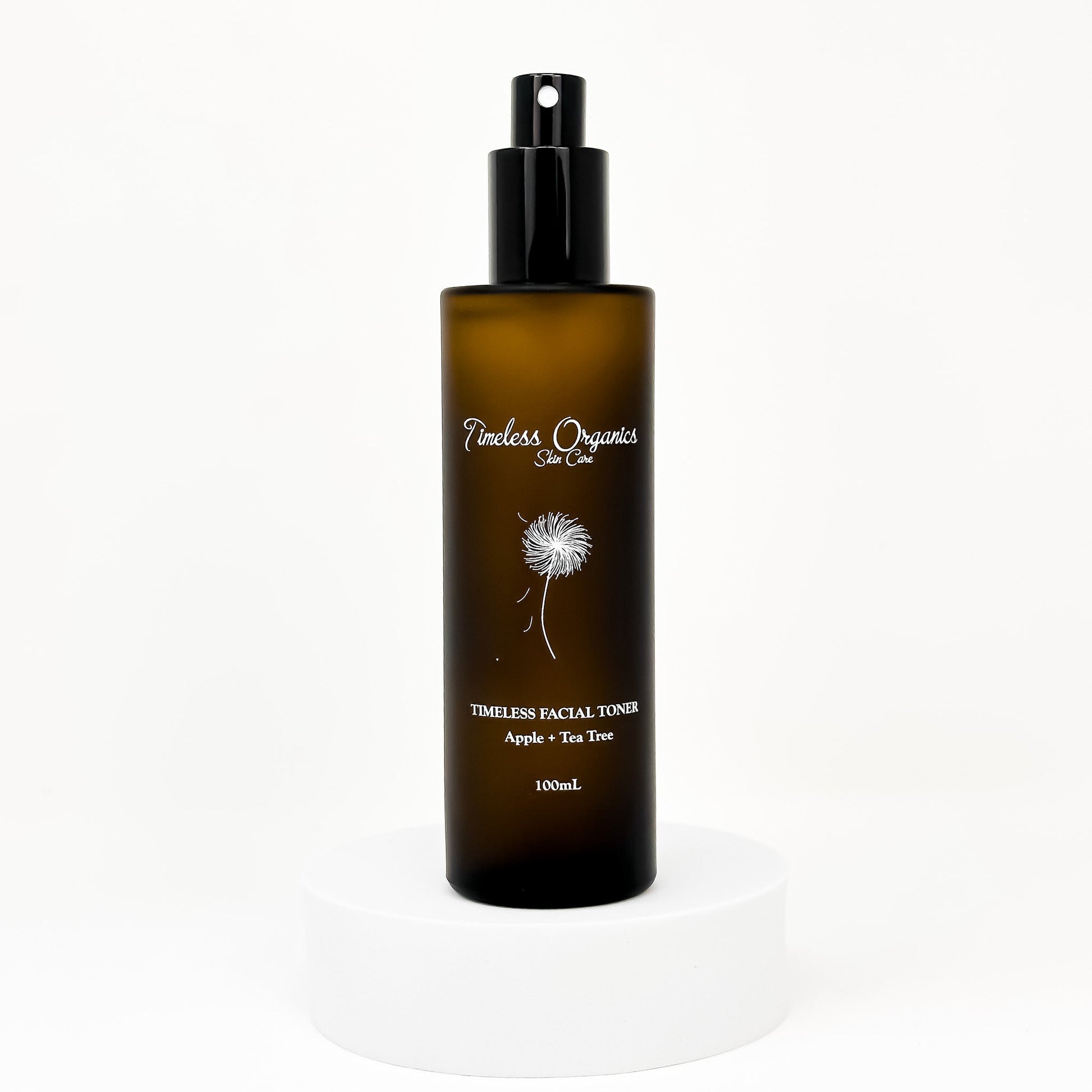 Clarifying facial toner bottle with black pump; amber bottle with dandelion label