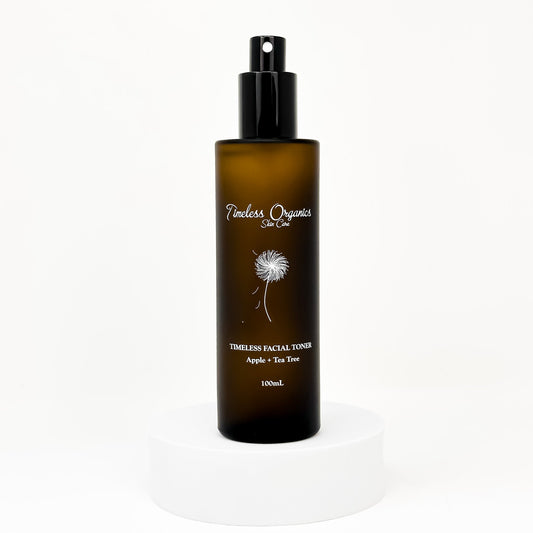 Clarifying facial toner bottle with black pump; amber bottle with dandelion label